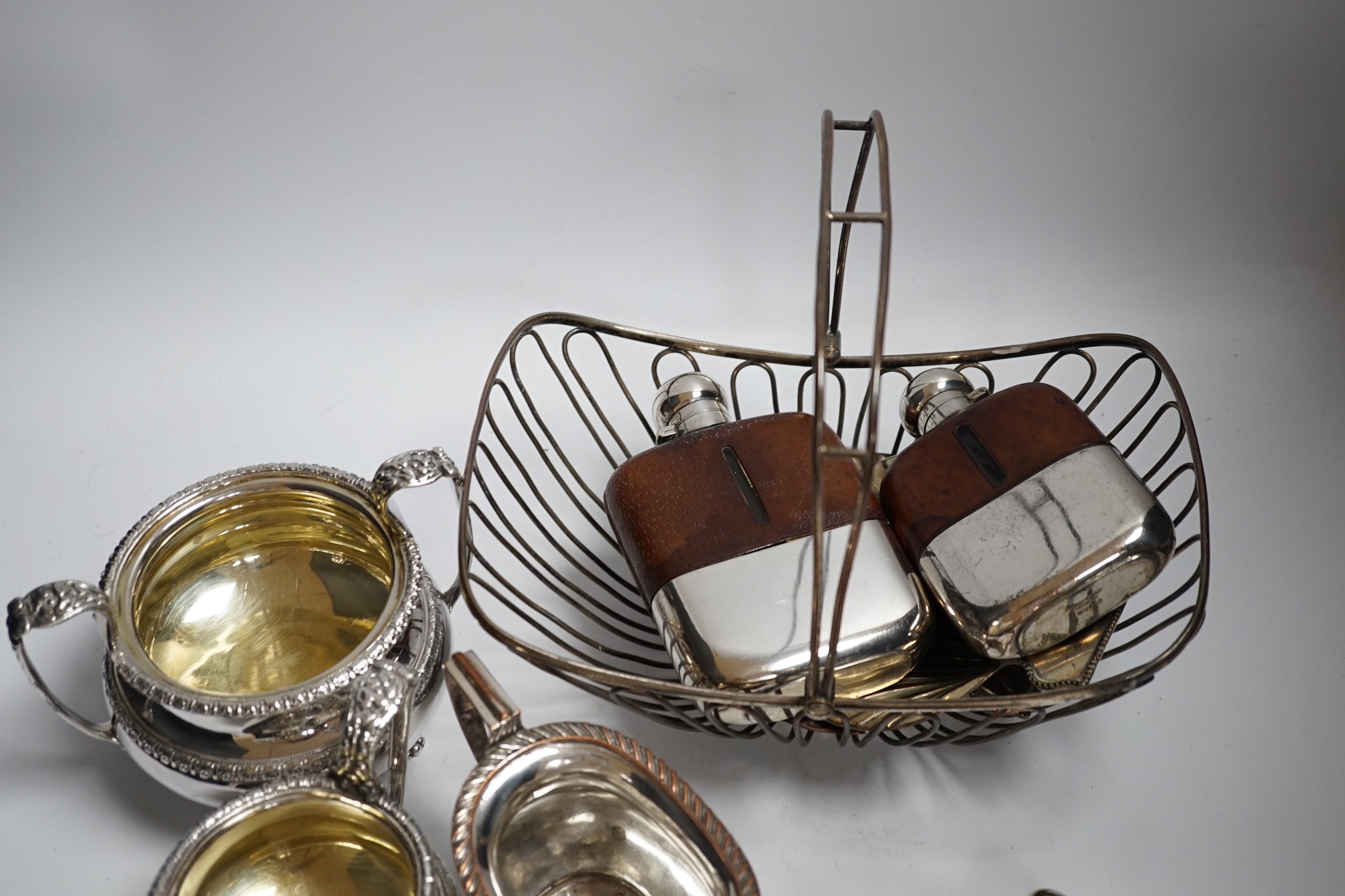 A group of silver plated ware, including four hip flasks